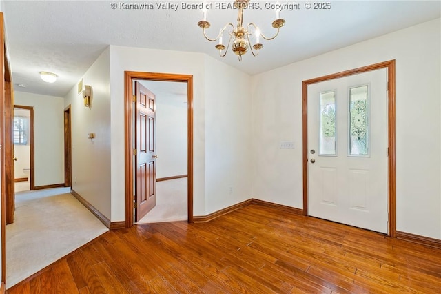 182 Summer Dr, Culloden, WV 25510 - foyer featuring wood finished floors, a chandelier, and healthy amount of natural light