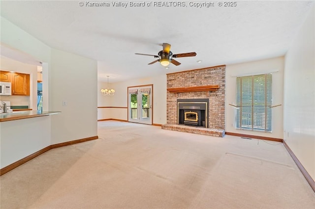 182 Summer Dr, Culloden, WV 25510 - unfurnished living room with light colored carpet, a brick fireplace, ceiling fan, and a chandelier