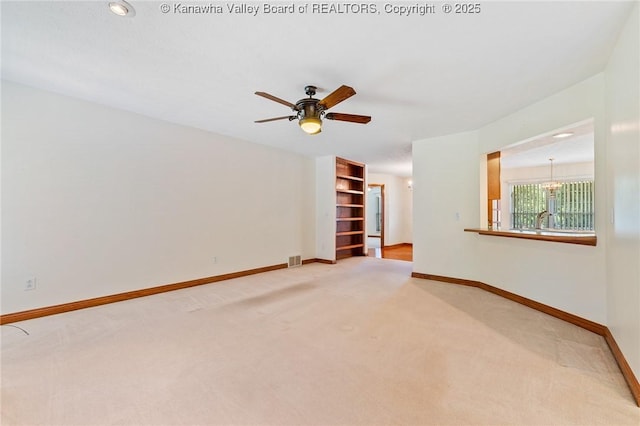 182 Summer Dr, Culloden, WV 25510 - spare room with light carpet, a ceiling fan, and a chandelier