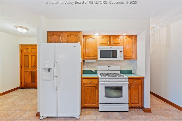182 Summer Dr, Culloden, WV 25510 - kitchen with white appliances, brown cabinets, light countertops, and a textured ceiling