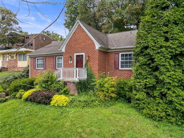 51 Roland Park Dr, Huntington, WV 25705 - view of front facade with brick siding, roof with shingles, and a front lawn
