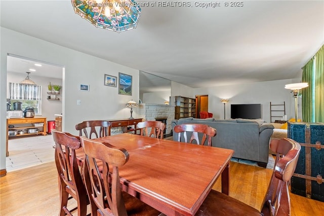 51 Roland Park Dr, Huntington, WV 25705 - dining room with a stone fireplace and light wood-style floors