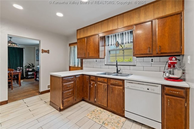 51 Roland Park Dr, Huntington, WV 25705 - kitchen featuring white dishwasher, tasteful backsplash, light countertops, a peninsula, and recessed lighting