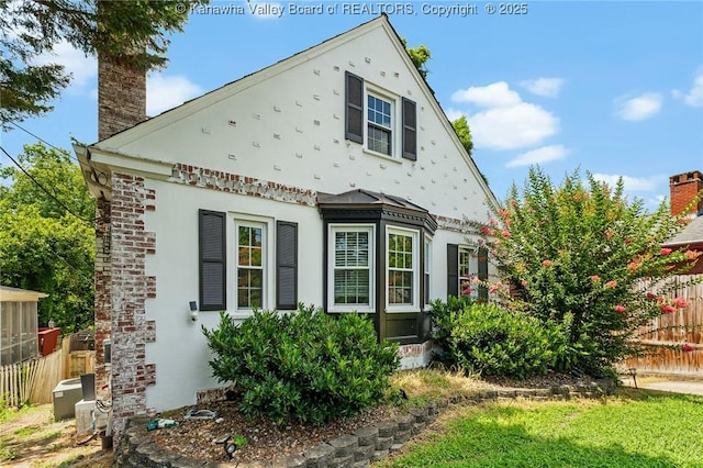 887 Poplar Rd, Charleston, WV 25302 - view of front of house with stucco siding and a chimney