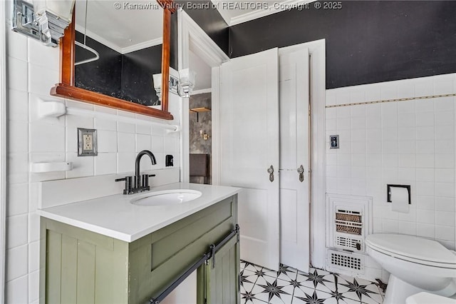 887 Poplar Rd, Charleston, WV 25302 - bathroom featuring tile walls, vanity, ornamental molding, tile patterned flooring, and heating unit