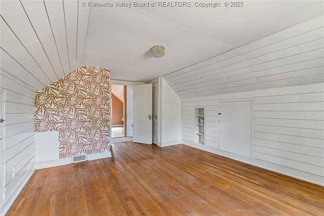 887 Poplar Rd, Charleston, WV 25302 - unfurnished living room with built in features, lofted ceiling, hardwood / wood-style flooring, and wooden walls