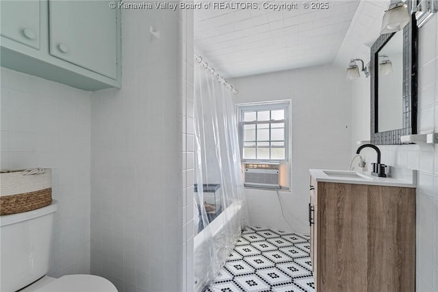 887 Poplar Rd, Charleston, WV 25302 - full bath featuring tile walls, vanity, cooling unit, and shower / bath combo with shower curtain
