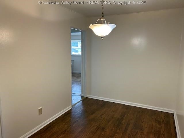3503 Virginia Ave SE, Charleston, WV 25304 - unfurnished dining area featuring dark wood finished floors and baseboards