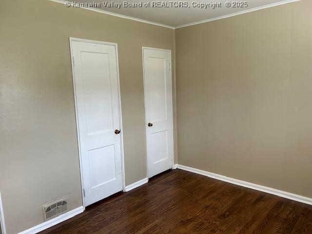 3503 Virginia Ave SE, Charleston, WV 25304 - unfurnished bedroom with dark wood-type flooring and ornamental molding