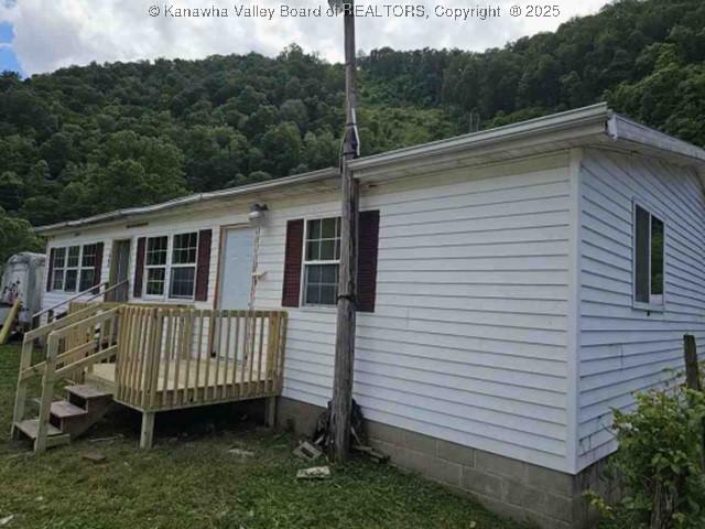120 Rainbow Cir, Madison, WV 25130 - rear view of house featuring a view of trees and a wooden deck