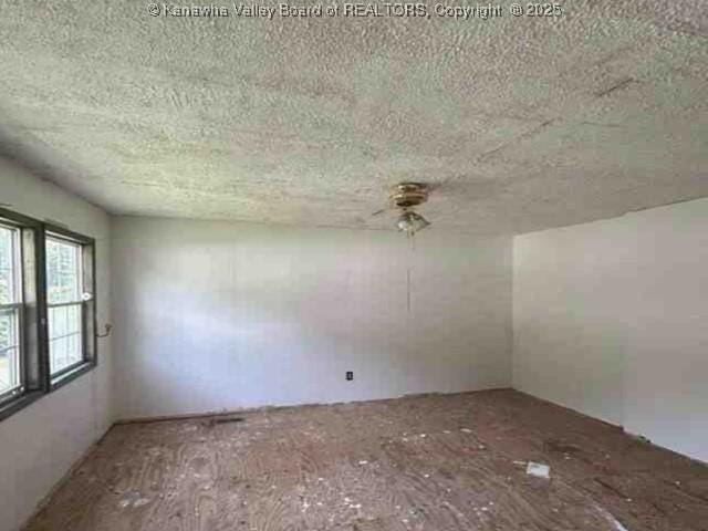 120 Rainbow Cir, Madison, WV 25130 - spare room featuring a textured ceiling