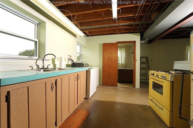 5126 Big Tyler Rd, Cross Lanes, WV 25313 - kitchen with gas range gas stove, concrete floors, washing machine and dryer, and light countertops