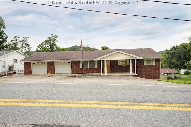 5126 Big Tyler Rd, Cross Lanes, WV 25313 - single story home featuring brick siding, an attached garage, covered porch, and concrete driveway
