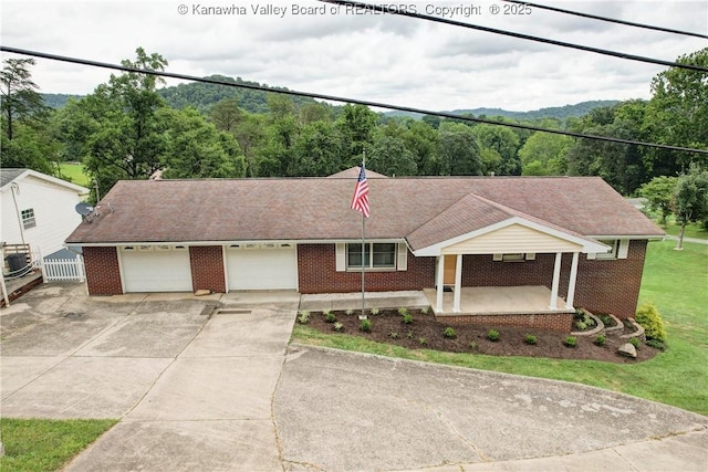 5126 Big Tyler Rd, Cross Lanes, WV 25313 - ranch-style home with concrete driveway, brick siding, and a garage