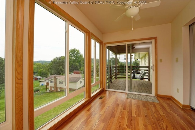 5126 Big Tyler Rd, Cross Lanes, WV 25313 - unfurnished sunroom featuring wood finished floors and baseboards
