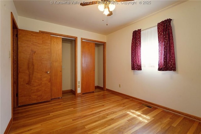 5126 Big Tyler Rd, Cross Lanes, WV 25313 - unfurnished bedroom featuring wood finished floors, two closets, and a ceiling fan