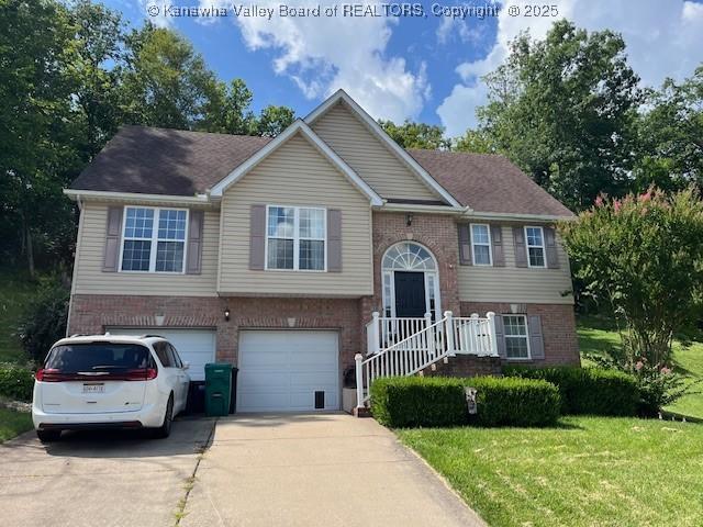 14 Perkins Way, Cross Lanes, WV 25313 - split foyer home with brick siding, driveway, a garage, and a front yard