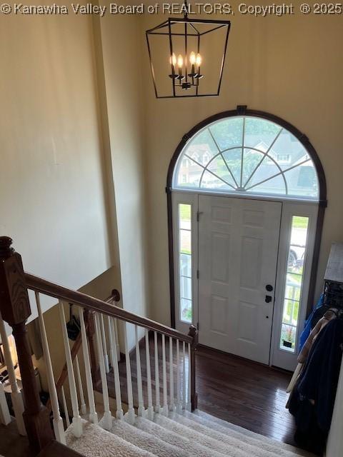14 Perkins Way, Cross Lanes, WV 25313 - entrance foyer with wood finished floors, a chandelier, and stairs