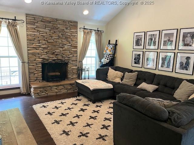14 Perkins Way, Cross Lanes, WV 25313 - living room featuring dark wood-type flooring, vaulted ceiling, a stone fireplace, and recessed lighting