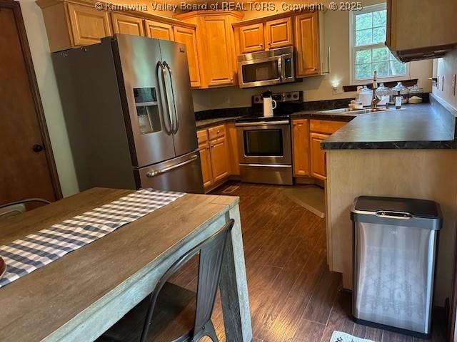 14 Perkins Way, Cross Lanes, WV 25313 - kitchen featuring appliances with stainless steel finishes, dark wood-style flooring, dark countertops, and brown cabinets