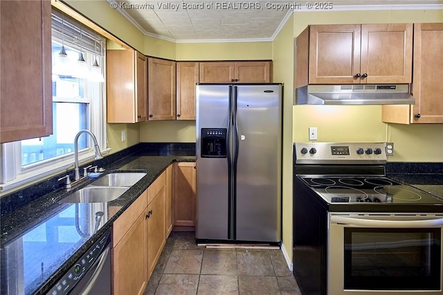 5309 Venable Ave SE, Charleston, WV 25304 - kitchen with appliances with stainless steel finishes, under cabinet range hood, ornamental molding, dark stone counters, and brown cabinetry