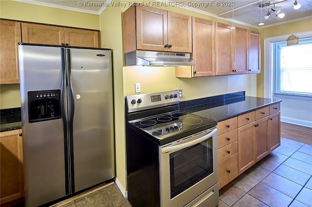 5309 Venable Ave SE, Charleston, WV 25304 - kitchen with stainless steel appliances, under cabinet range hood, ornamental molding, dark tile patterned floors, and dark stone counters