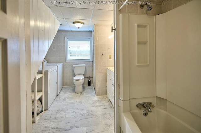 5309 Venable Ave SE, Charleston, WV 25304 - full bath featuring independent washer and dryer, vanity, tile walls, shower / washtub combination, and marble finish floors