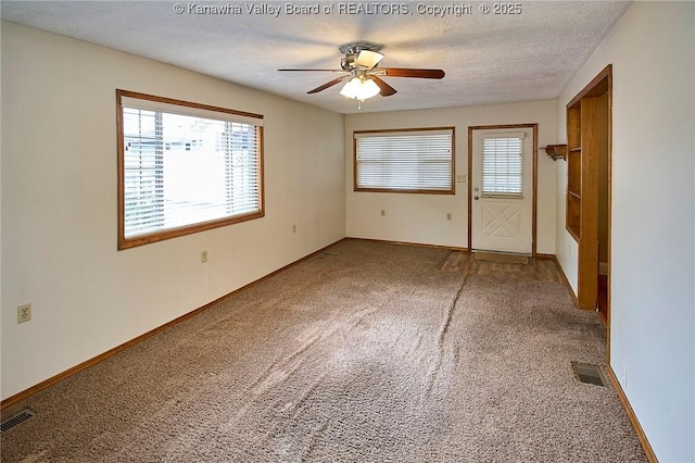 5309 Venable Ave SE, Charleston, WV 25304 - unfurnished bedroom featuring carpet flooring, multiple windows, a textured ceiling, and a ceiling fan