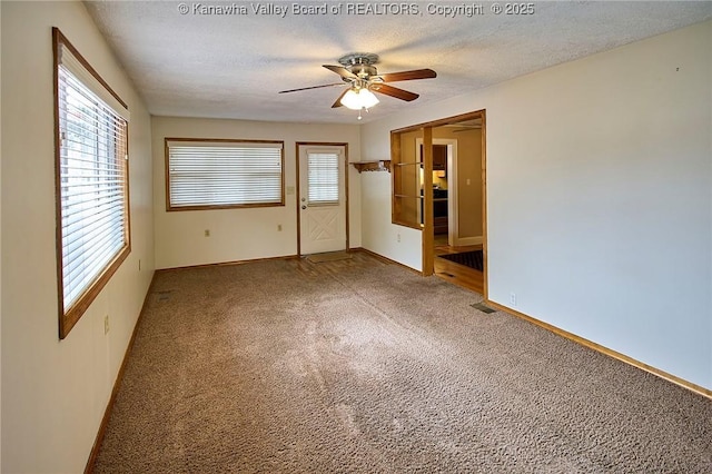 5309 Venable Ave SE, Charleston, WV 25304 - empty room with light carpet, ceiling fan, and a textured ceiling