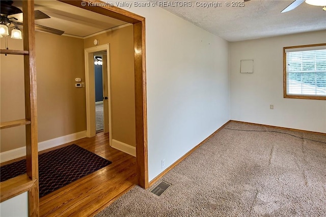 5309 Venable Ave SE, Charleston, WV 25304 - empty room featuring a ceiling fan, carpet floors, a textured ceiling, and wood finished floors