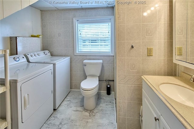 5309 Venable Ave SE, Charleston, WV 25304 - bathroom with washer and clothes dryer, tile walls, vanity, and marble finish floors