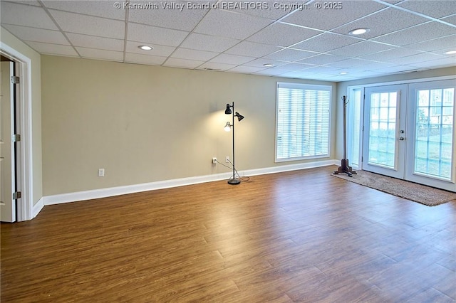 5309 Venable Ave SE, Charleston, WV 25304 - empty room featuring plenty of natural light, dark wood finished floors, french doors, and a drop ceiling