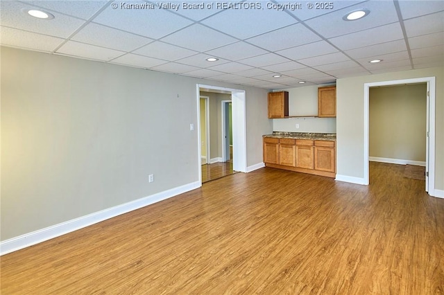 5309 Venable Ave SE, Charleston, WV 25304 - kitchen with a drop ceiling, wood finished floors, brown cabinets, recessed lighting, and open floor plan