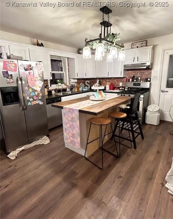 59 Pleasant Ln, Grantsville, WV 25147 - kitchen with stainless steel appliances, butcher block countertops, under cabinet range hood, white cabinetry, and a kitchen island