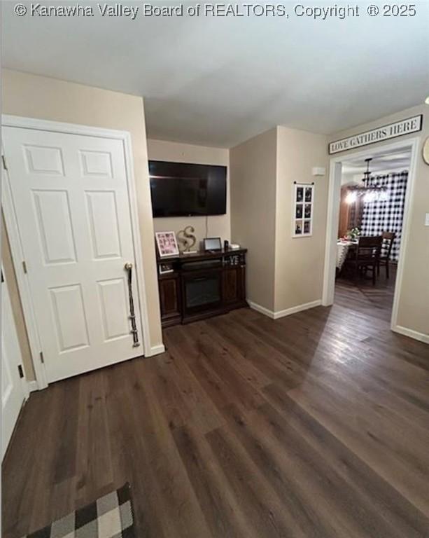 59 Pleasant Ln, Grantsville, WV 25147 - living area with dark wood-style flooring and a chandelier