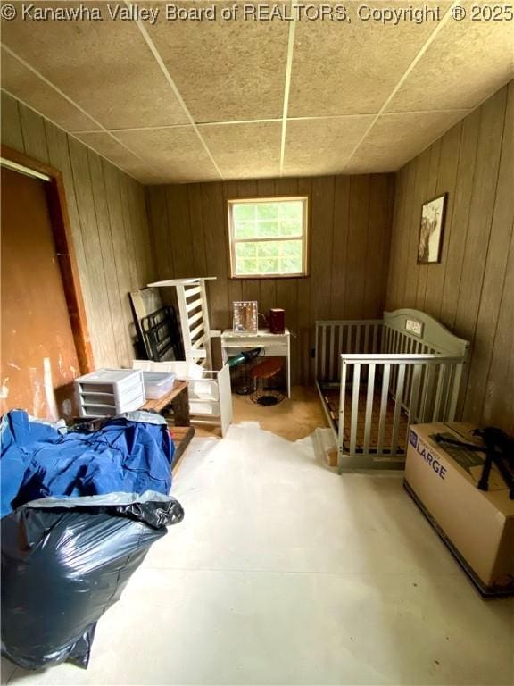 1091/2 Hillcrest Dr, Ripley, WV 25271 - bedroom with wood walls and concrete floors