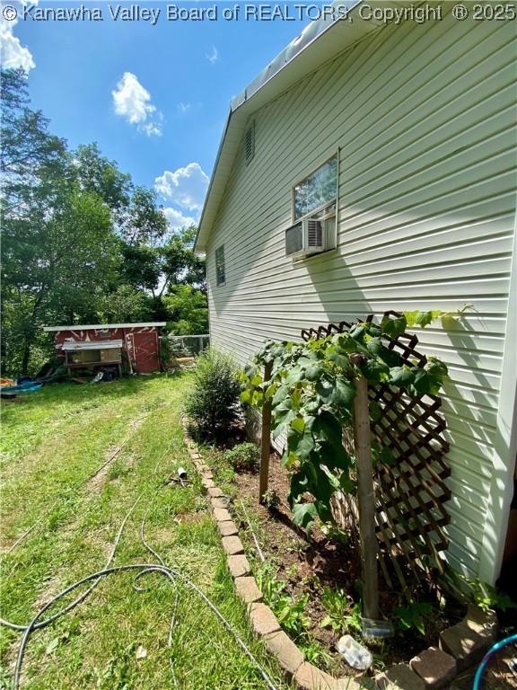 1091/2 Hillcrest Dr, Ripley, WV 25271 - view of property exterior featuring cooling unit and a lawn
