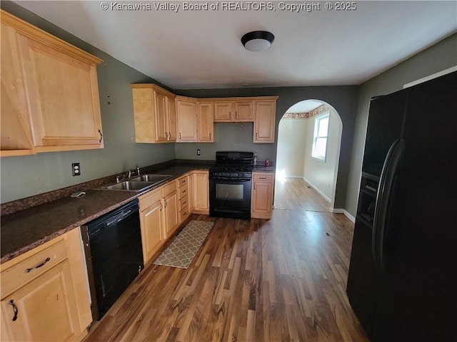 814 Madison Ave, Spencer, WV 25276 - kitchen featuring black appliances, light brown cabinetry, arched walkways, and dark wood-style floors