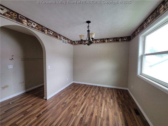814 Madison Ave, Spencer, WV 25276 - spare room with arched walkways, wood finished floors, and a chandelier