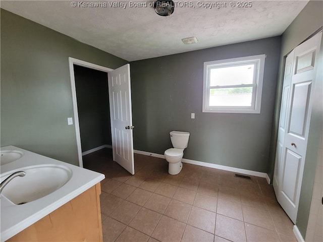 814 Madison Ave, Spencer, WV 25276 - bathroom with double vanity, tile patterned flooring, and a textured ceiling