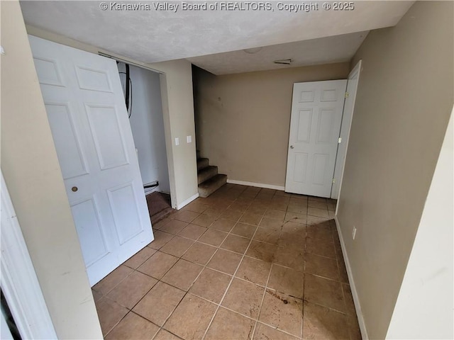 814 Madison Ave, Spencer, WV 25276 - spare room with stairway, light tile patterned flooring, and baseboard heating