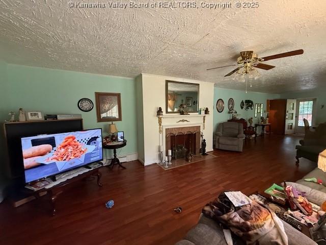 1022 Riverside Dr, Welch, WV 24801 - living area featuring a textured ceiling, a ceiling fan, wood finished floors, and a fireplace with flush hearth