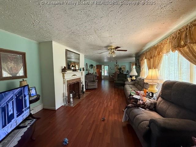 1022 Riverside Dr, Welch, WV 24801 - living area featuring ceiling fan, wood finished floors, a fireplace with flush hearth, and a textured ceiling