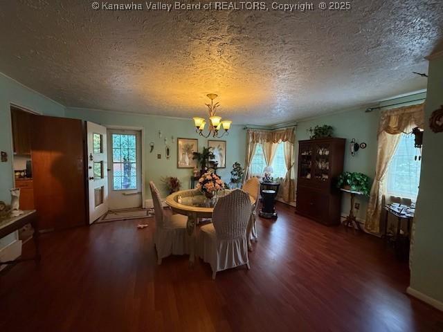 1022 Riverside Dr, Welch, WV 24801 - dining area featuring a chandelier, wood finished floors, and a textured ceiling