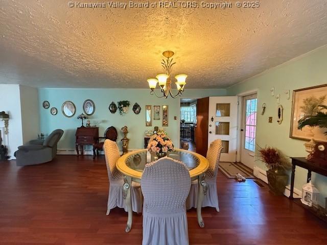 1022 Riverside Dr, Welch, WV 24801 - dining area featuring a textured ceiling, a chandelier, wood finished floors, and baseboard heating