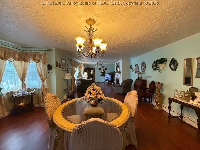 1022 Riverside Dr, Welch, WV 24801 - dining area featuring wood finished floors, a chandelier, and a textured ceiling