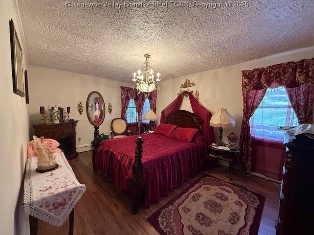 1022 Riverside Dr, Welch, WV 24801 - bedroom featuring a textured ceiling, a chandelier, and wood finished floors