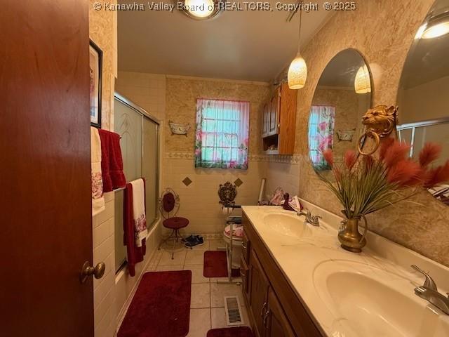 1022 Riverside Dr, Welch, WV 24801 - bathroom with tile patterned floors, double vanity, and shower / bath combination with glass door