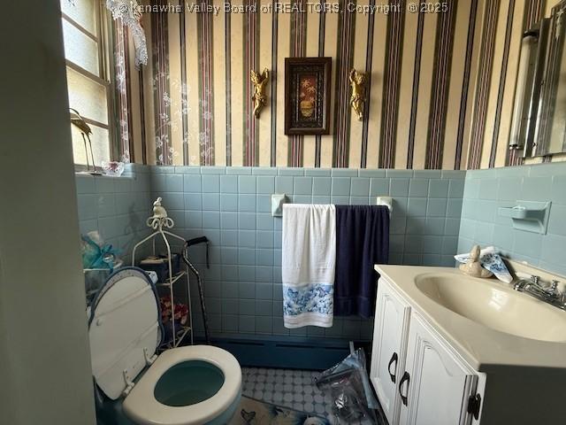 1022 Riverside Dr, Welch, WV 24801 - bathroom featuring tile walls, vanity, wallpapered walls, and plenty of natural light