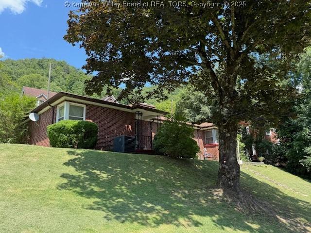 1022 Riverside Dr, Welch, WV 24801 - view of front of property with brick siding and a front lawn